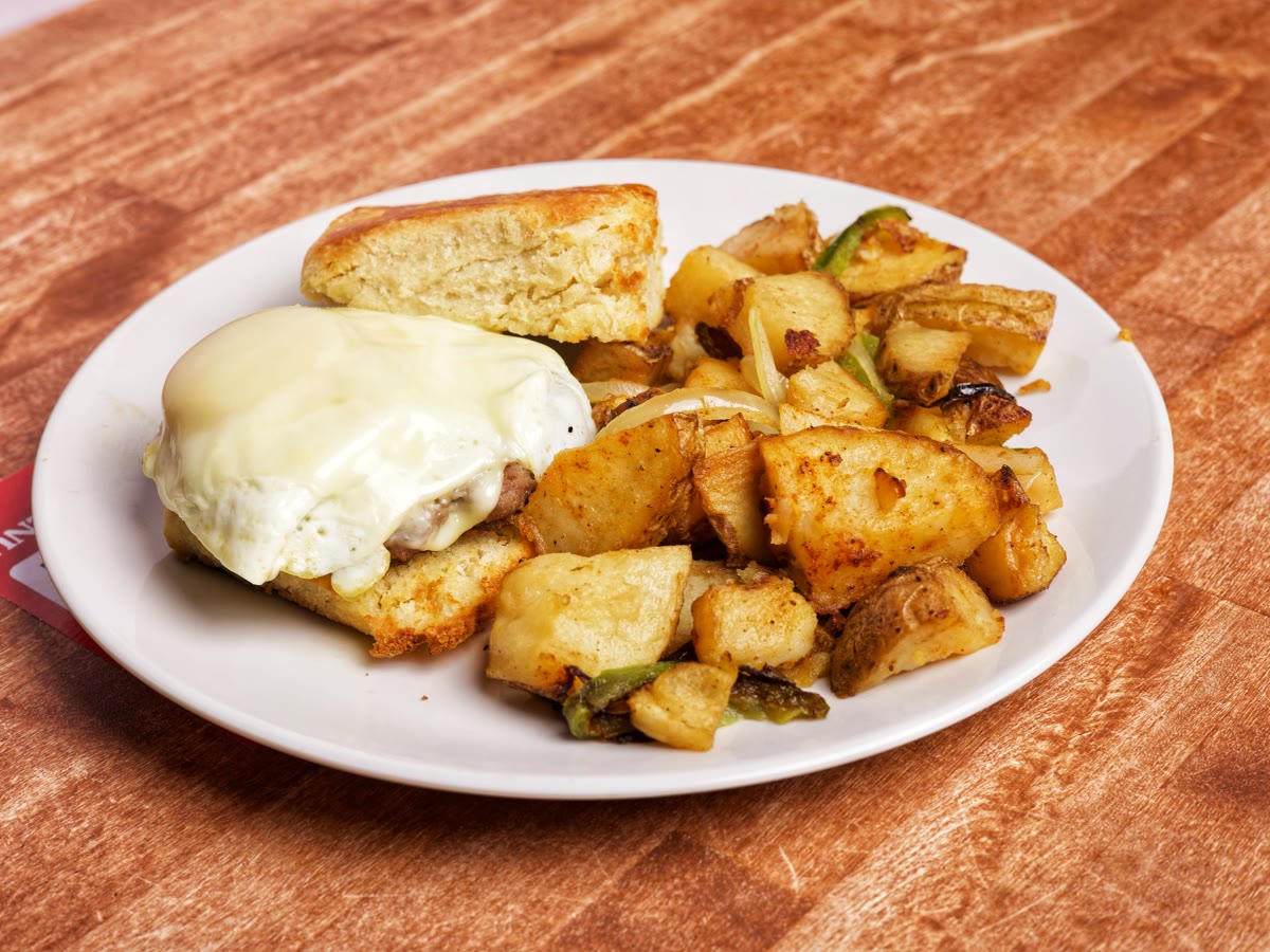 Honey butter biscuit sandwich with fried chicken, egg and cheese